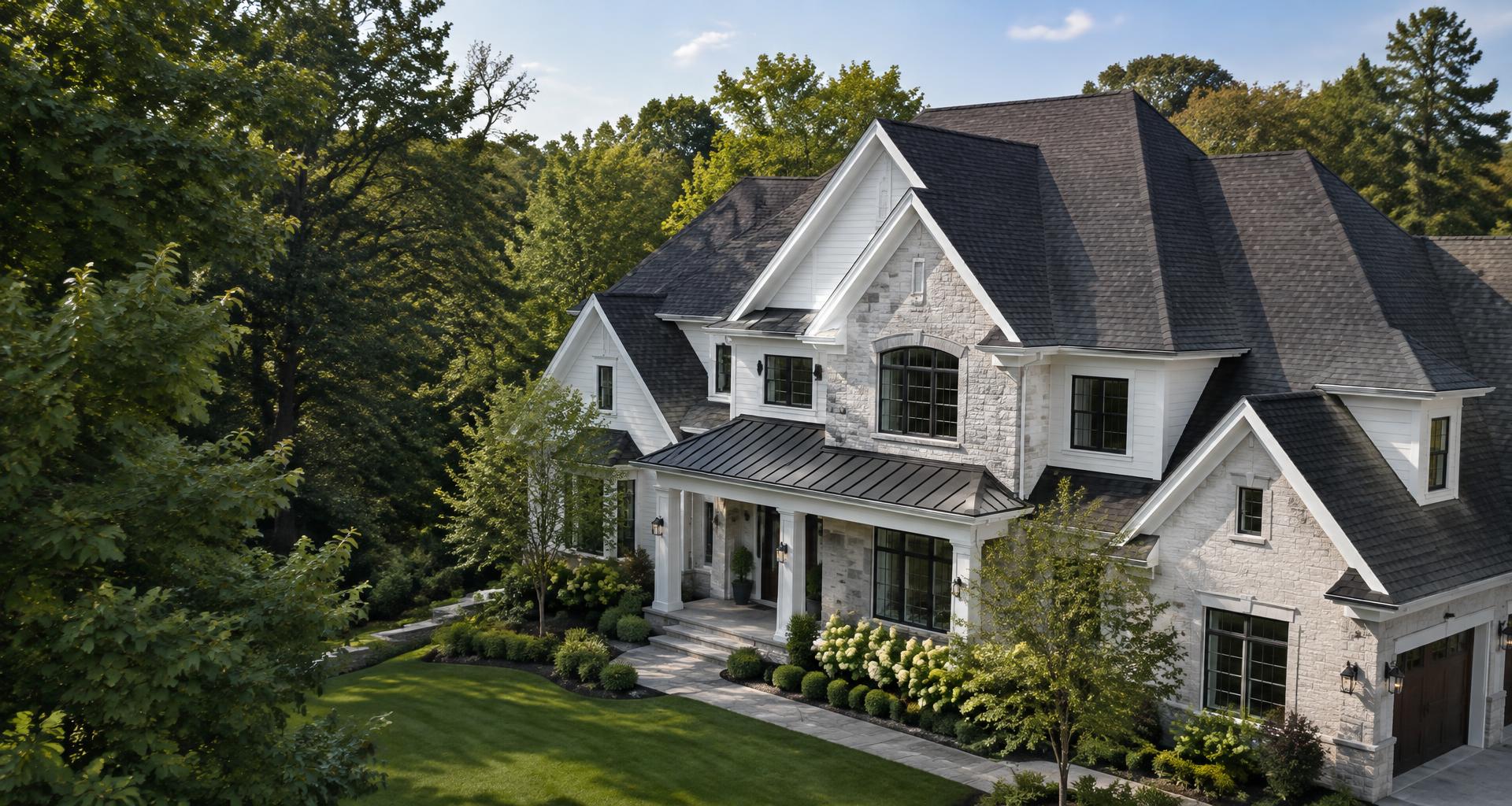 Architectural shingle and metal accent roof on an elegant white home